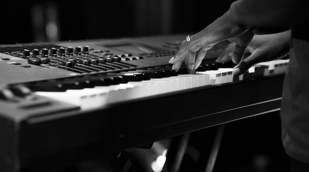 Sound engineer adjusting an audio mixing console